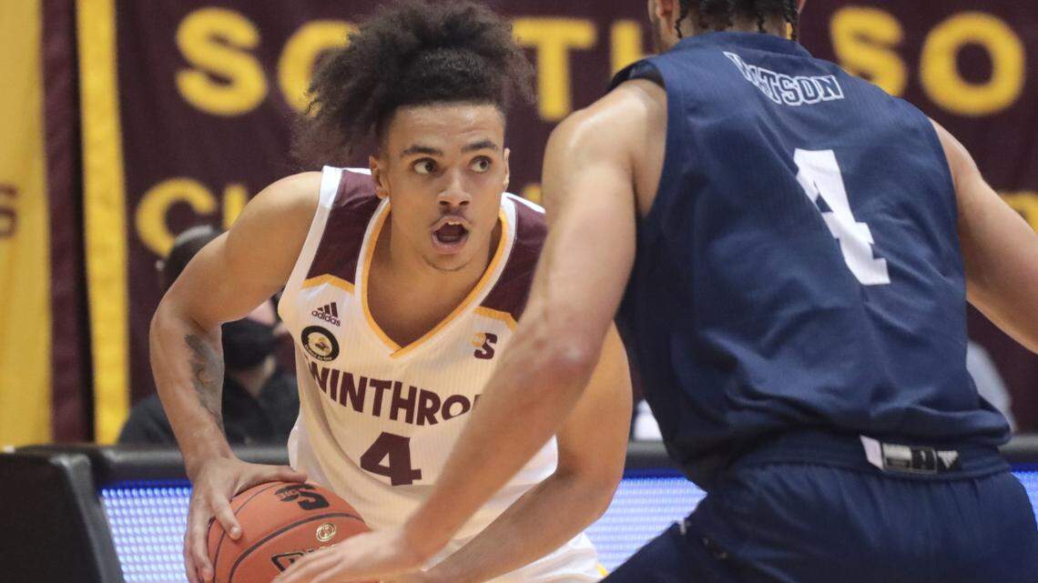 Winthrop’s Kelton Talford waits for an opening against Longwood’s Zac Watson.