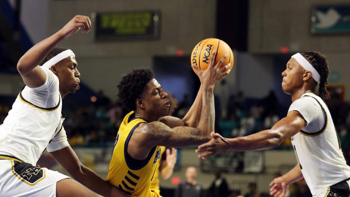 Lancaster’s Jordan Watford, center, tries to get to the basket around North Augusta’s Jamison Mckenzie, left, and Daron Dunbar Friday at the Class 4A state championships in Florence