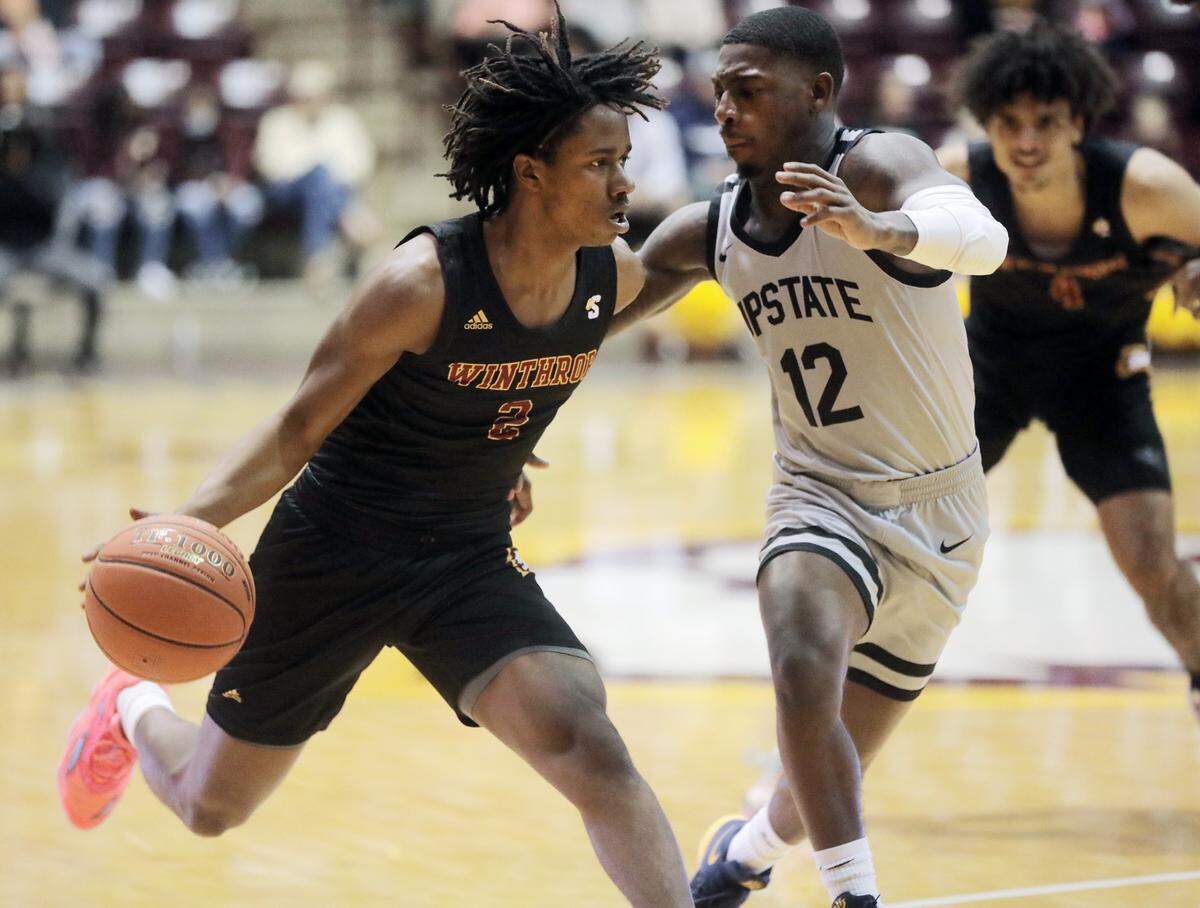 Winthrop’s Sin’cere McMahon dribbles past Upstate’s Dalvin White.