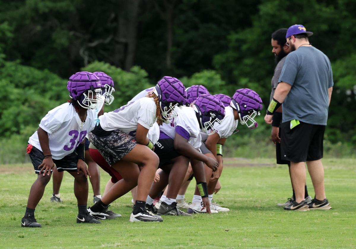 Northwestern High School varsity football players practice after school on Thursday.