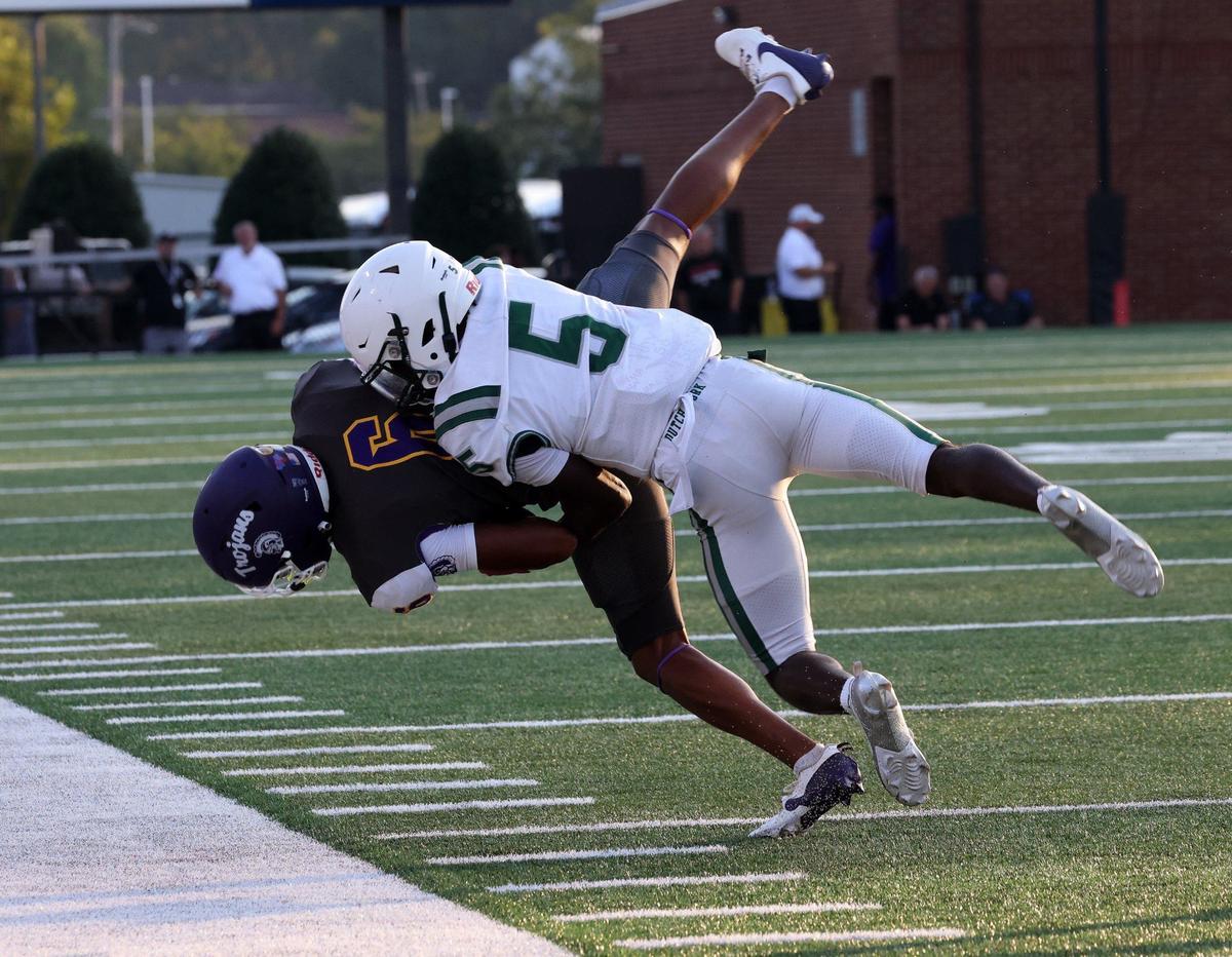 Dutch Fork’s Malachi Smith brings down Northwestern’s Daniel Caldwell Friday at the WRHI Football City USA scrimmage in Rock Hill.