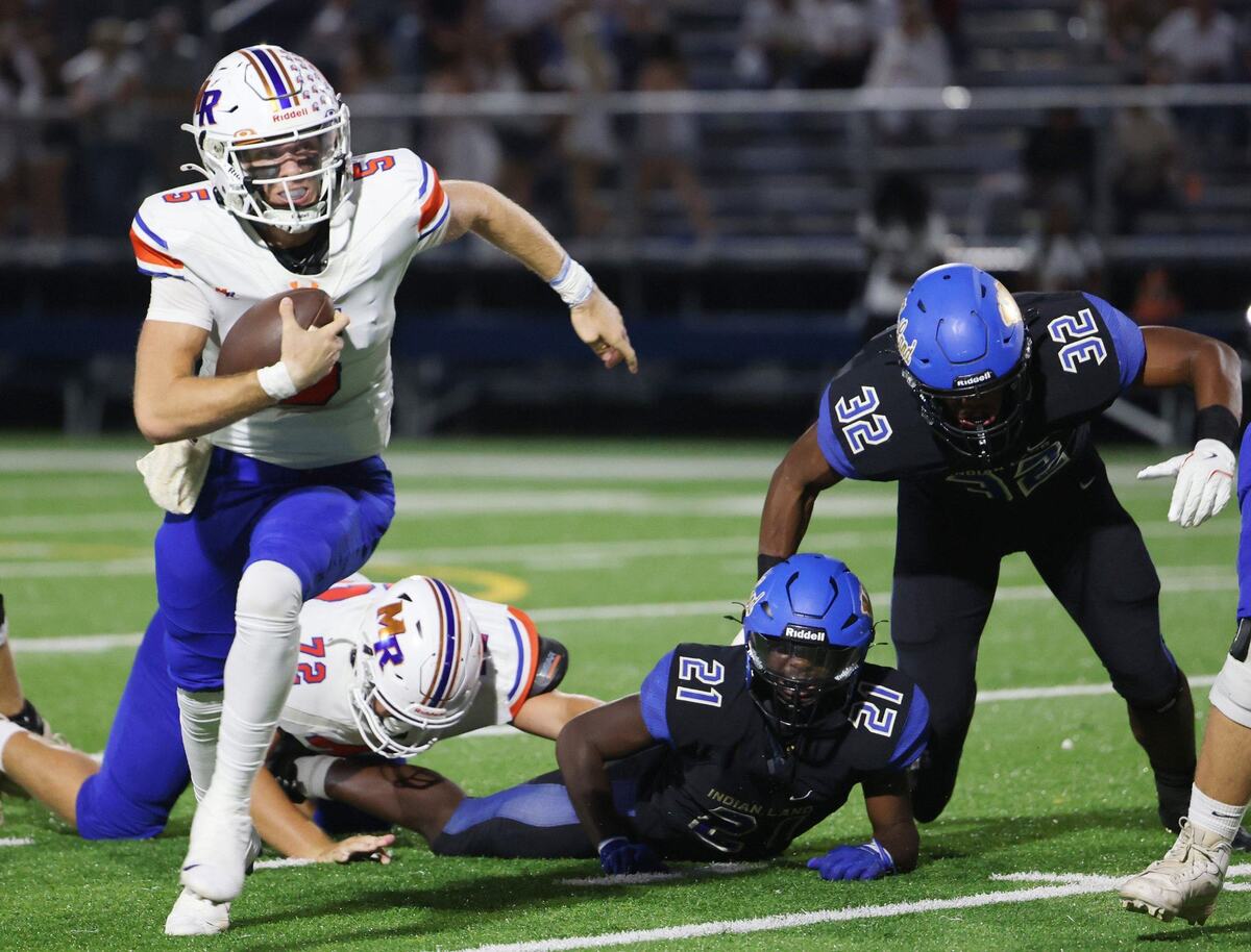 Marvin Ridge’s Braydon Rediger, left, carries the ball against Indian Land’s Leonard Goethe Jr. (21) and Michael Foster (32) as Beau Gerrard (72) falls behind.