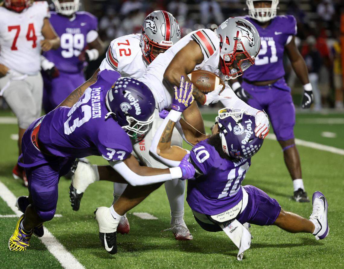 Northwestern's Kamerin McFadden (33) and Jayden Baxter bring down South Pointe's Kadin Watkins Friday, Sept. 12, 2025 in Rock Hill, S.C.