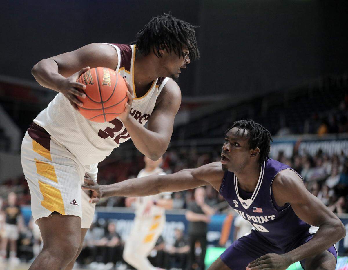Winthrop’s D.J. Burns Jr. tries to pass High Point’s Emmanuel Izunabor.