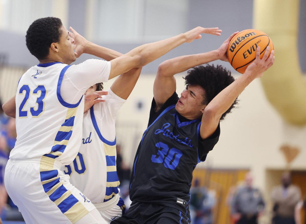 Indian Land’s Brent Micheal Terrell (23) and Donovin Jones (30) try to block Fort Mill’s Logan Parker Friday in Indian Land.