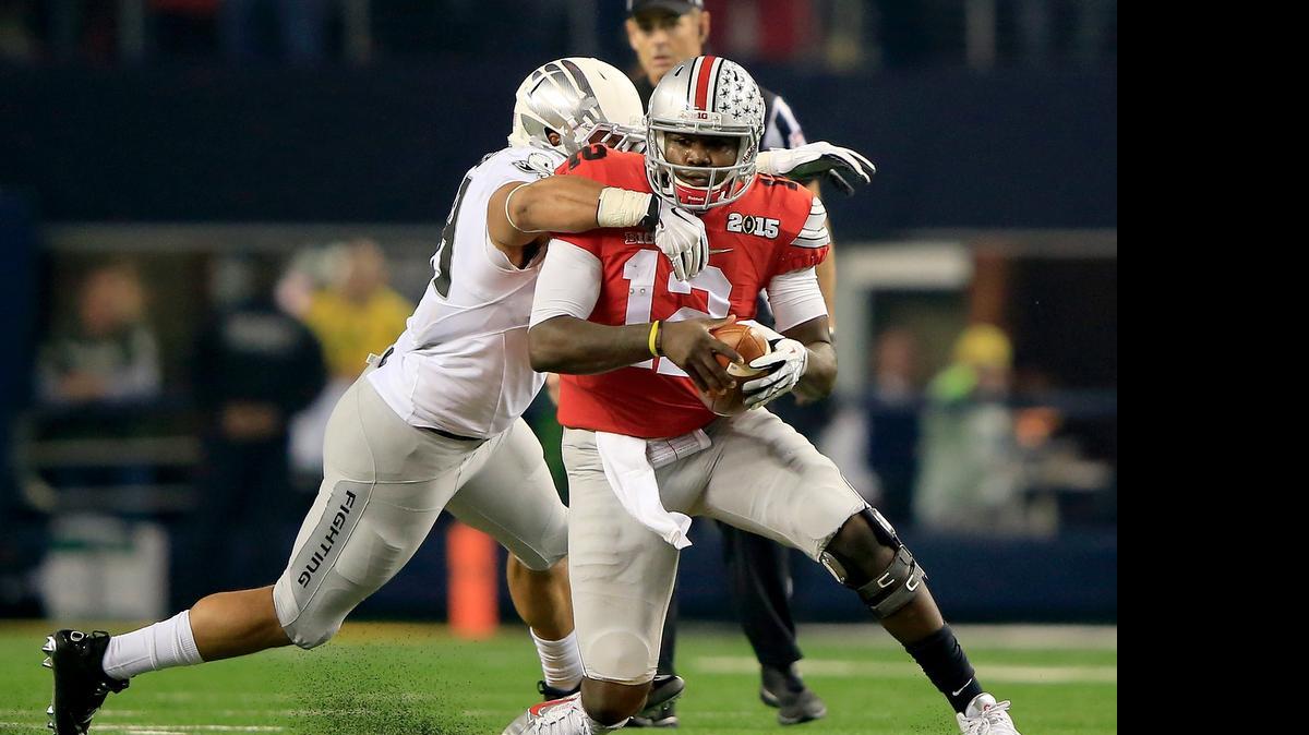
Ohio State quarterback Cardale Jones (12) looks to avoid a sack against Oregon during the College Football Playoff National Championship Game at AT&T Stadium on Jan. 12, 2015 in Arlington, Texas. 


