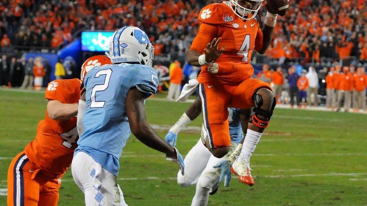 Clemson quarterback Deshaun Watson (4) leaps into the air as he crosses the goal line for a touchdown in the fourth quarter against North Carolina in the ACC Football Championship at Bank of America Stadium in Charlotte