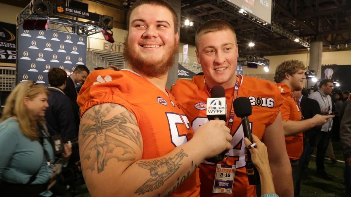 Tigers center Jay Guillermo (57) interviews teammate Pat Godfrey (64) during Media Day at the Phoenix Convention Center in downtown Phoenix, Ariz., on Jan. 9.