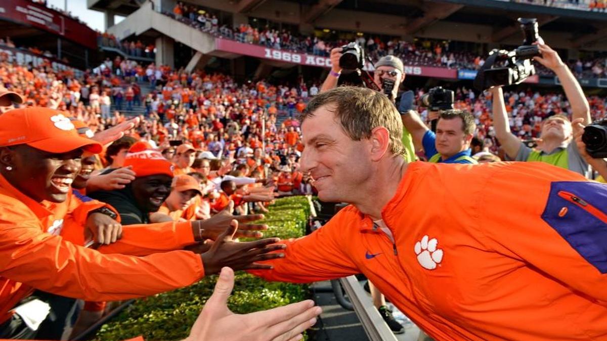 Clemson head coach Dabo Swinney celebrates with the fans after a 37-32 win over South Carolina Saturday.