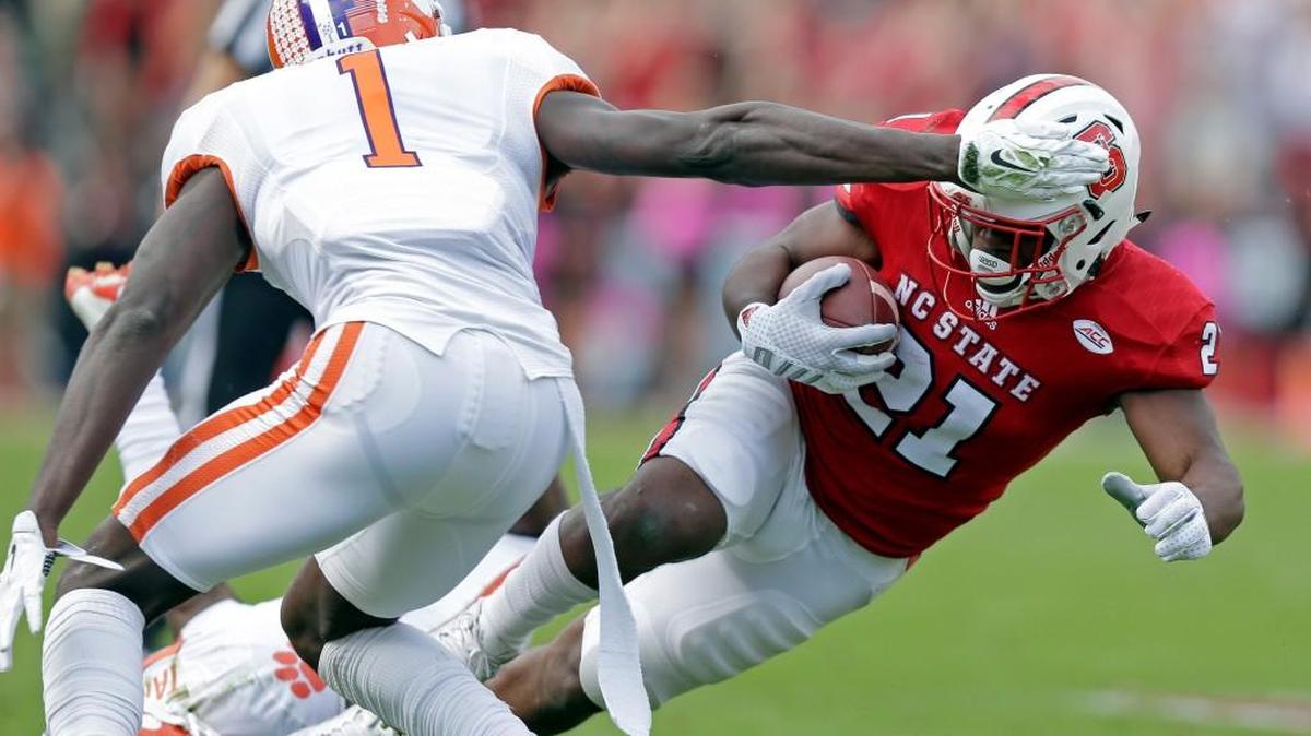 Clemson's Jayron Kearse (1) reaches for North Carolina State's Matthew Dayes (21) during the first half of Saturday’s game.