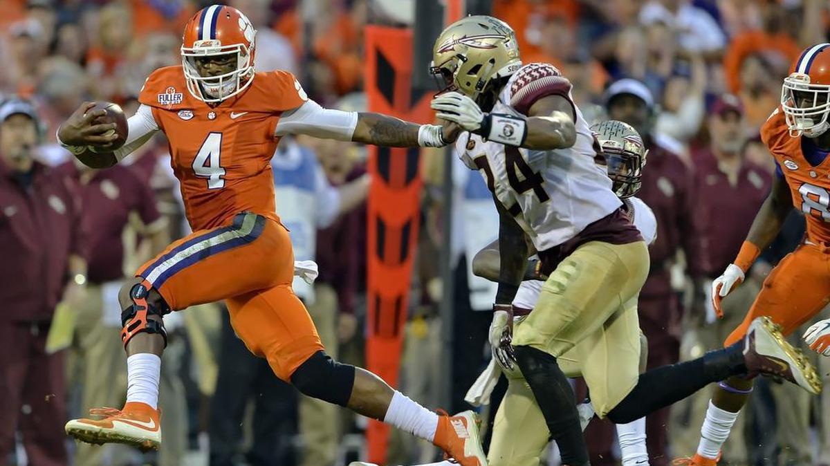 Clemson quarterback Deshaun Watson (4) fends off Florida State’s Terrance Smith to gain a first down during the first half on Saturday in Clemson.