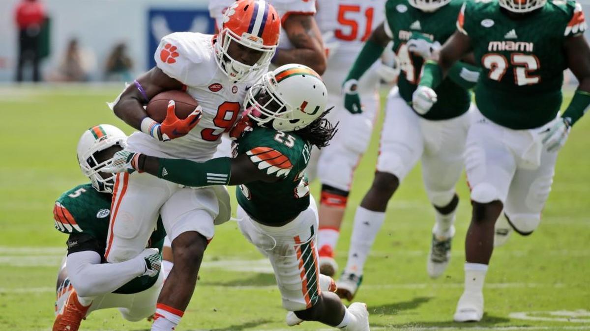 Clemson running back Wayne Gallman (9) is tackled by Miami linebacker Jermaine Grace (5) and defensive back Dallas Crawford (25) Saturday.