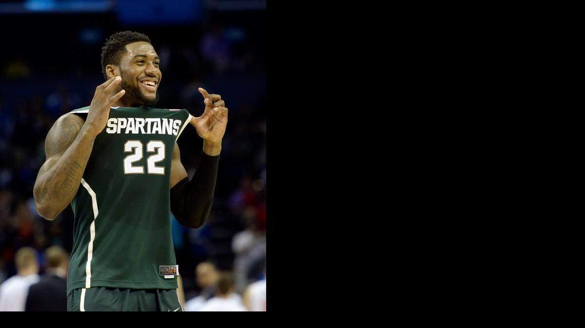 
Michigan State’s Branden Dawson celebrates the Spartans’ upset victory against No. 2 seed Virginia in the NCAA tournament in Charlotte. Michigan State won 60-54 to advance to the Sweet 16.
