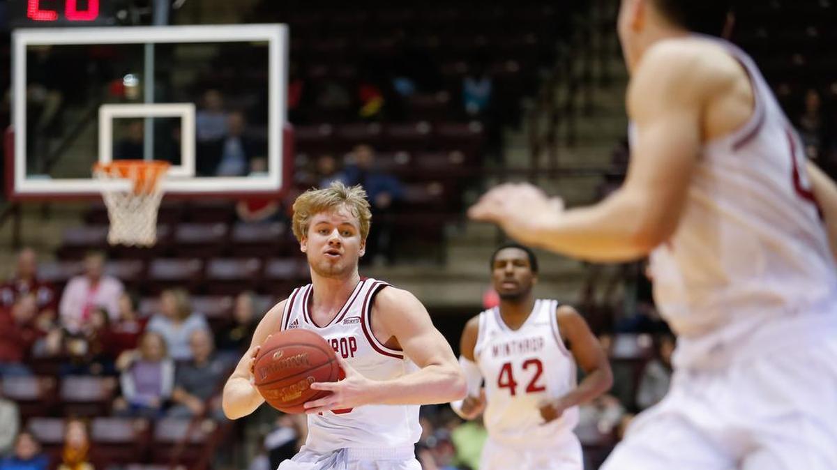 Winthrop's No. 13 Bjorn Broman passes to No. 44 Jimmy Gavin as Winthrop hosts Radford in Big South men's basketball.