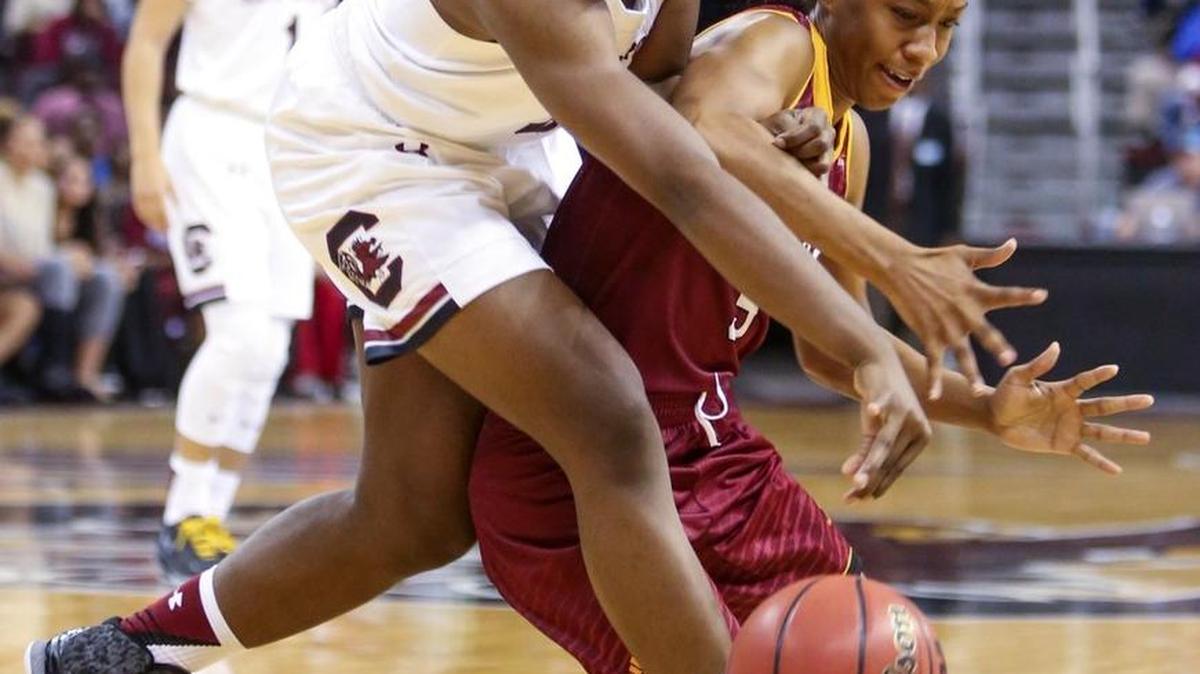South Carolina’s Kaydra Duckett (3) and Winthrop’s Nuba Jackson (5) chase a loose ball during the second half of Sunday’s game.