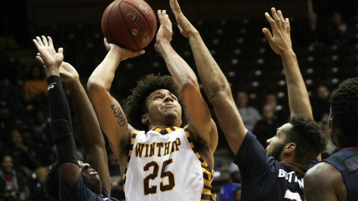 Winthrop's Josh Ferguson shoots against South Carolina State's Damani Applewhite, left, and David Bottenberg.