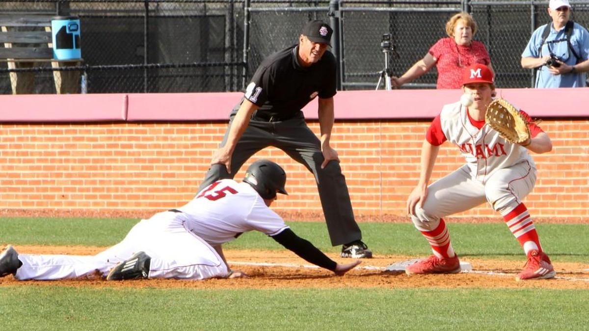 Winthrop’s Mark Lowrie slides back into first base against Miami’s Ross Haffey.