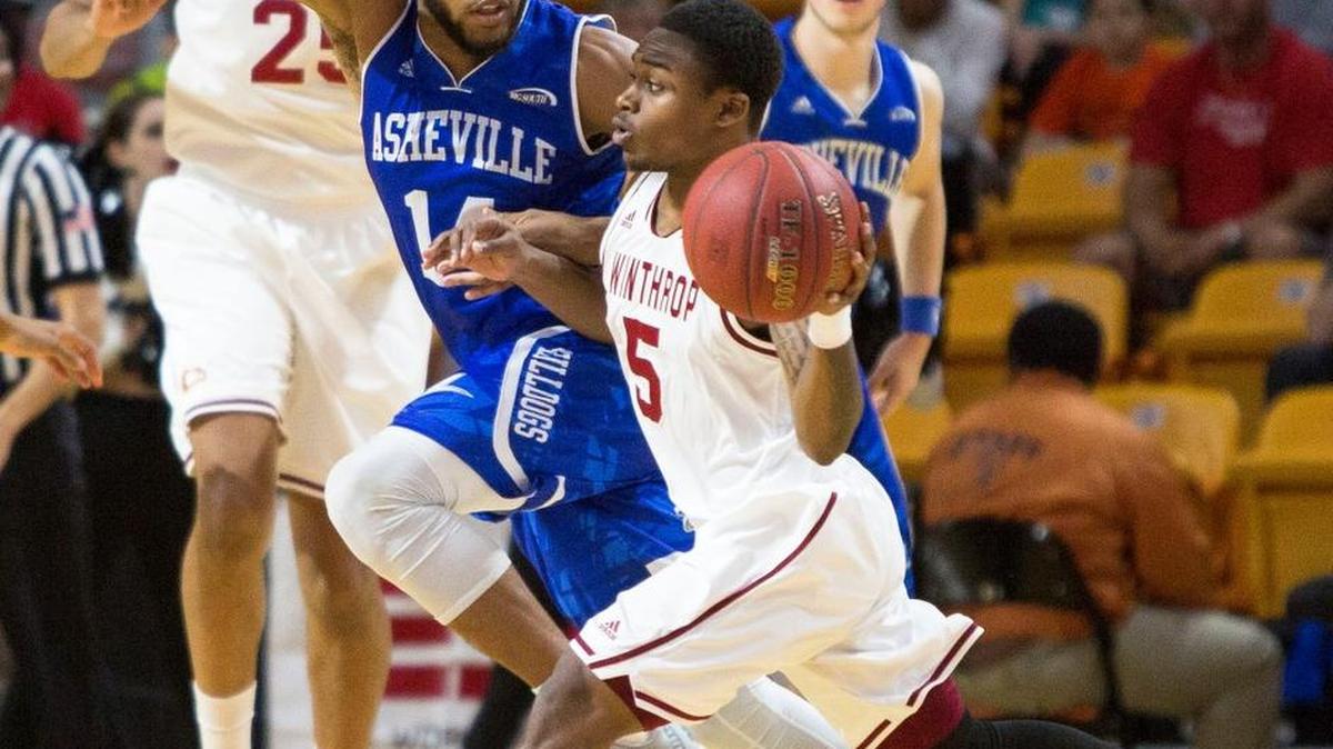 Winthrop’s Keon Johnson (5) handles the ball as UNC Asheville’s Ahmad Thomas (14) defends during the first half of an NCAA college basketball championship game in the Big South Conference tournament in Buies Creek, N.C., Sunday, March 6, 2016.