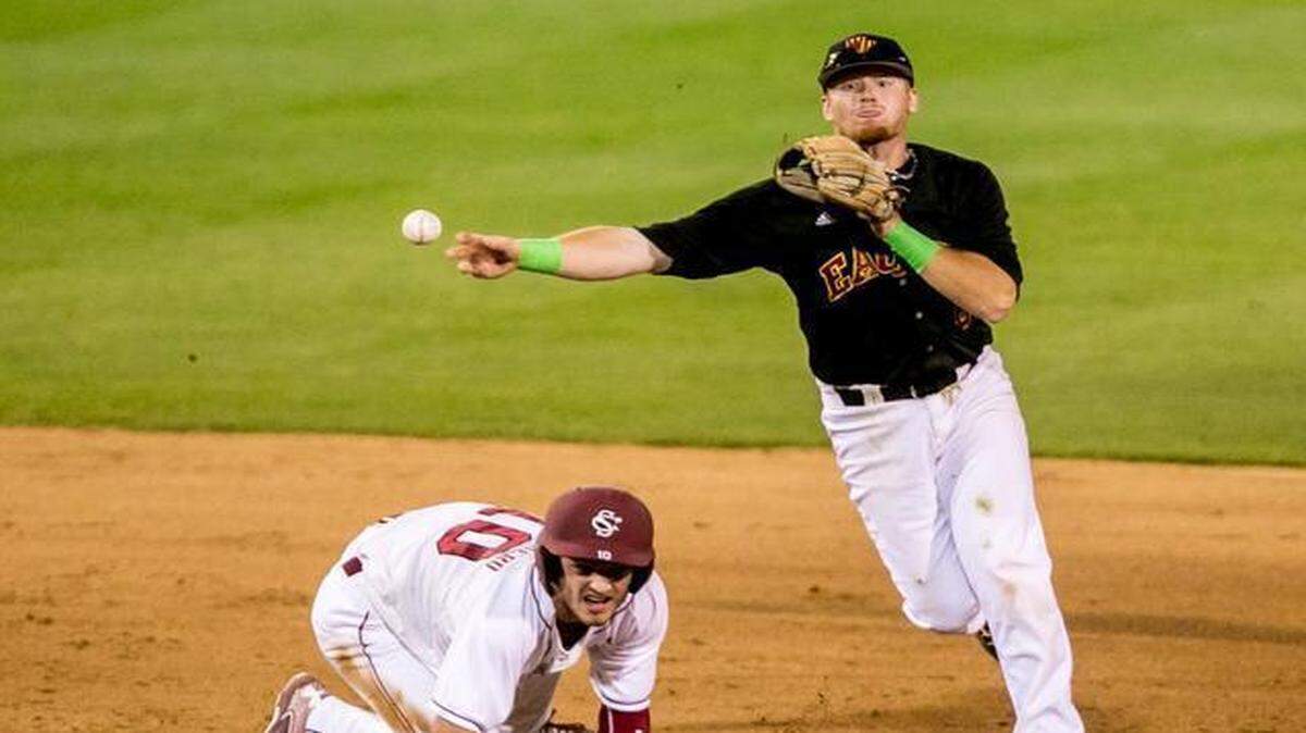 
Winthrop shortstop Kyle Edwards turns a double play over South Carolina’s Clark Scolamiero in the seventh inning at Carolina Field in Columbia, on Tuesday. 

