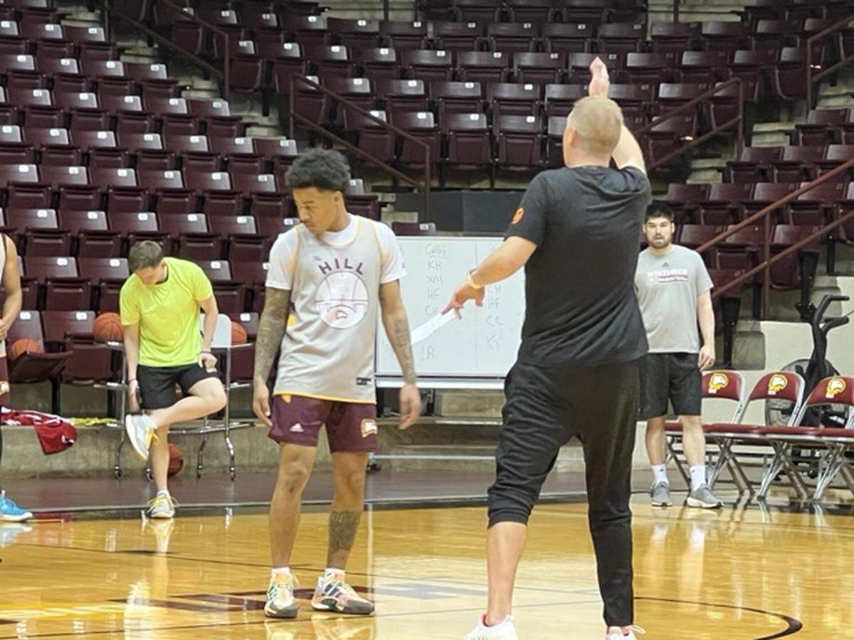 Prosser (black shirt, black pants) talks to his players at practice on Dec. 30. He said that his team made a really good defensive showing down the stretch against UNC Asheville and expects that play to continue throughout the season.