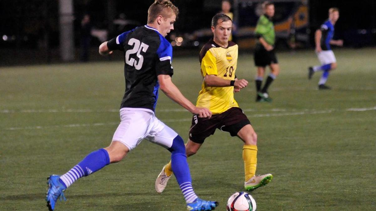 Winthrop senior Patrick Barnes, right, and UNC Asheville sophomore Zach Compton go for the ball during their quarterfinal match Tuesday at Manchester Meadows in Rock Hill.