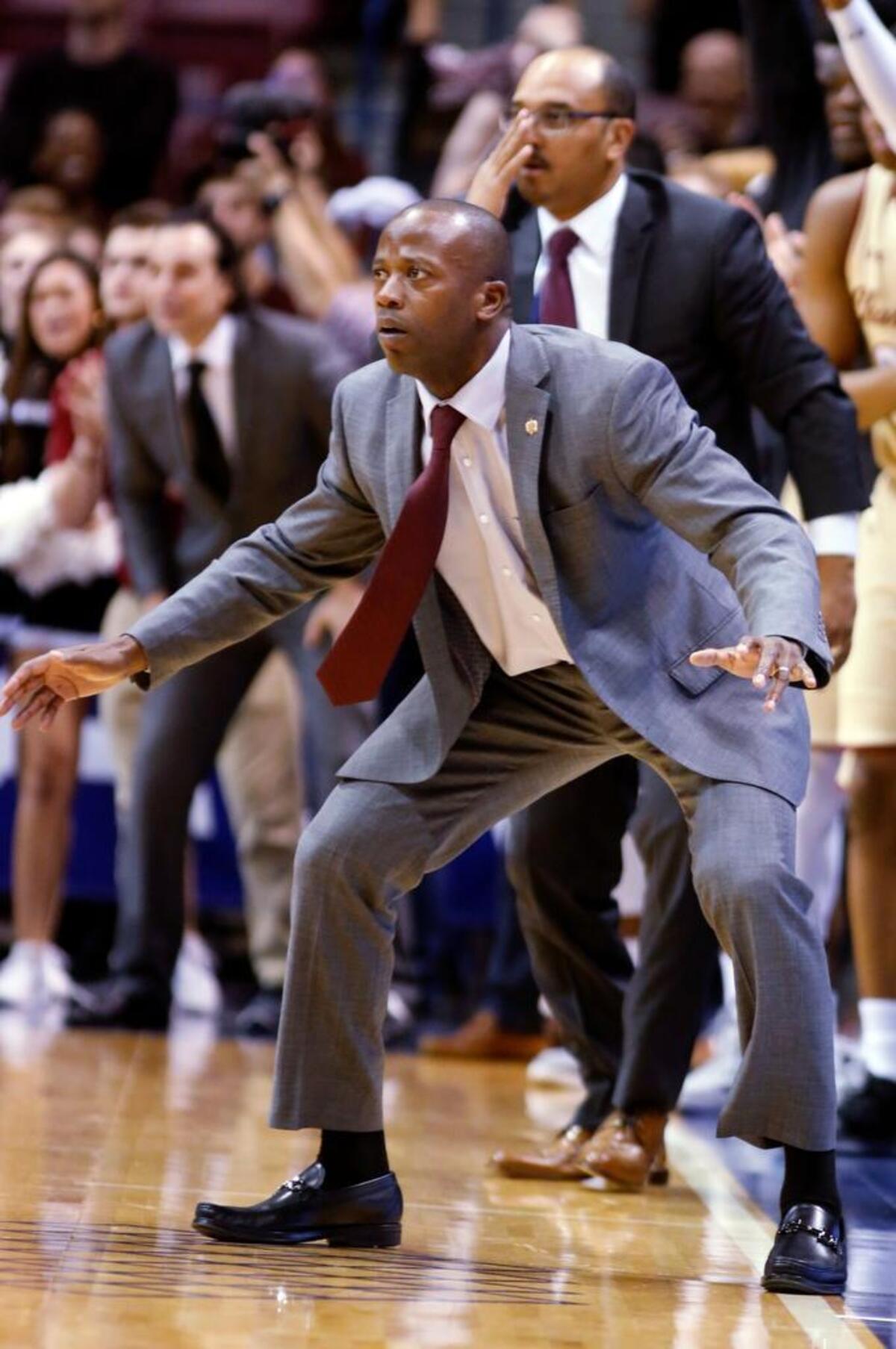 College of Charleston's head coach Earl Grant watches his team as they come back from a double-digit deficit against Northeastern in the second half of an NCAA college championship basketball game in the Colonial Athletic Association tournament at the North Charleston Coliseum in North Charleston, S.C., Tuesday, March 6, 2018. College of Charleston won 83-76 in overtime.
