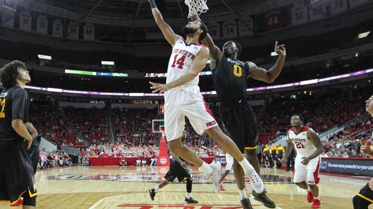 N.C. State’s Caleb Martin (14) puts in two past Winthrop’s Duby Okeke (0) in the second half during N.C. State’s 87-79 victory over Winthrop at PNC Arena in Raleigh, N.C. on Nov. 27.