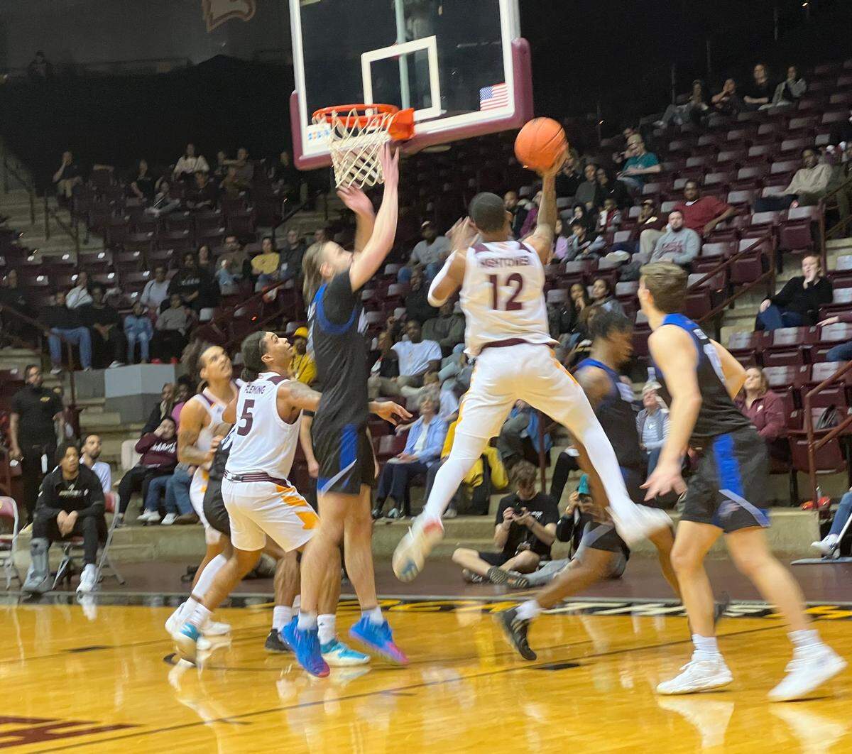 Cory Hightower (12) goes in for a layup over UNC Asheville’s Drew Pember. Hightower finished the game with seven points, eight rebounds and four assists.