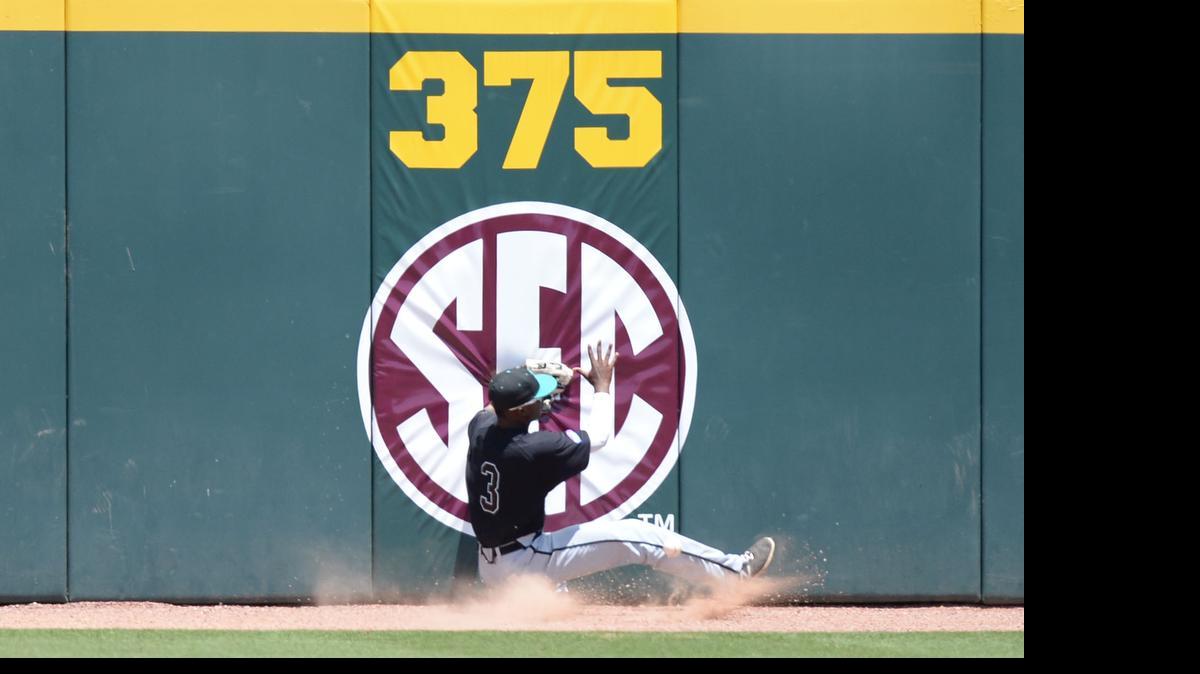 
Coastal Carolina's Josh Crump (3) runs into the left field wall while trying to make a catch during an NCAA college regional baseball tournament game against Texas A&M in College Station, Texas, on Sunday, May 31. Crump, the former Northwestern Trojan standout, appeared in 45 games for the Chanticleers as a true freshman this spring.
