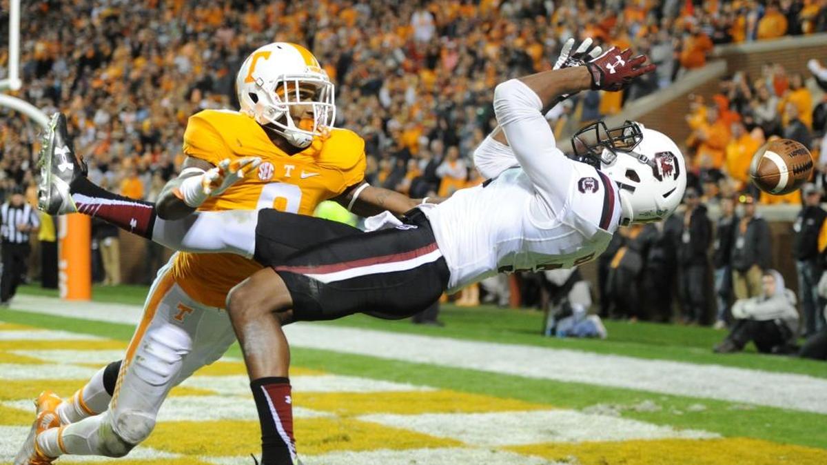 South Carolina wide receiver D.J. Neal, right, reaches for a pass over Tennessee defensive back Justin Martin during the second half in Knoxville, Tenn. on Saturday.