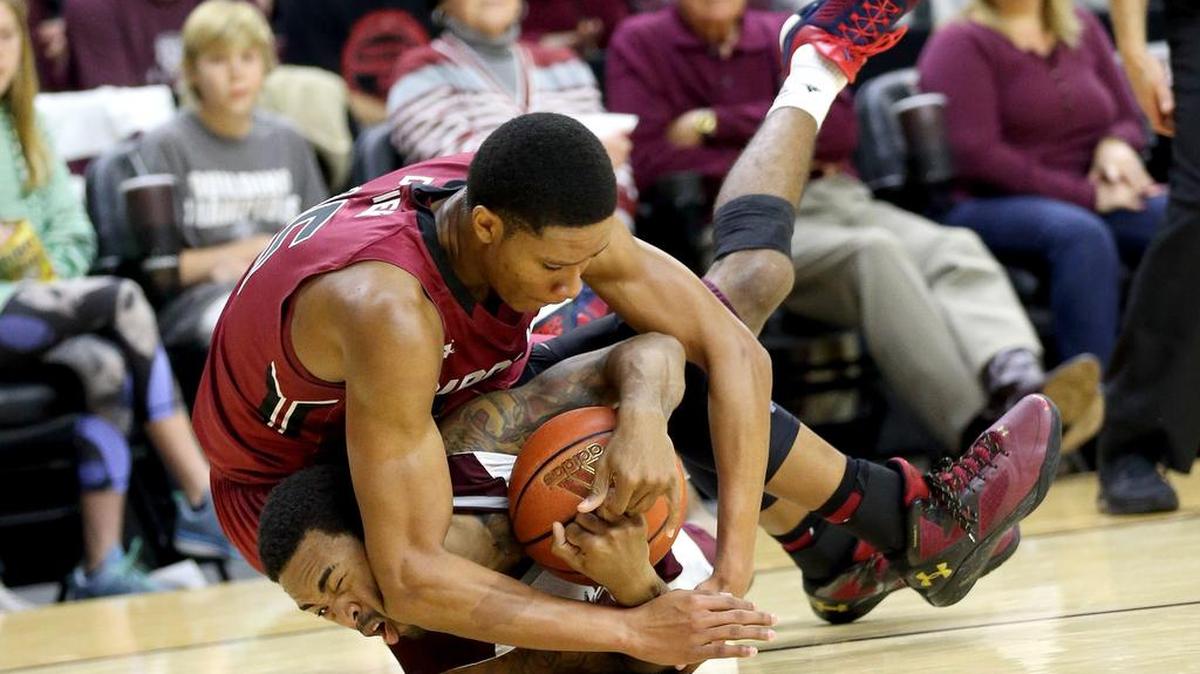 Texas A&M’s Anthony Collins, bottom, fights for a loose ball with South Carolina’s PJ Dozier during the first half on Saturday. The Gamecocks went 12 of 21 from 3-point range, including 7 for 10 in the first half and won 81-78.