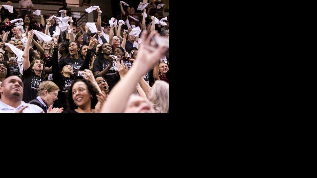 
South Carolina Coach Dawn Staley and Lisa Boyer, surrounded by players and fans, react to the Gamecocks being chosen as a first seed in the Greensboro regional of the NCAA tournament during a celebration in the Colonial Life Arena Monday. 
