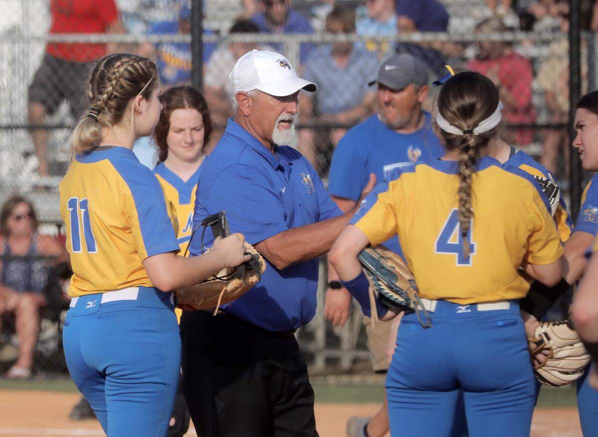 Fort Mill High School softball coach Chuck Stegall talks to his team between innings.