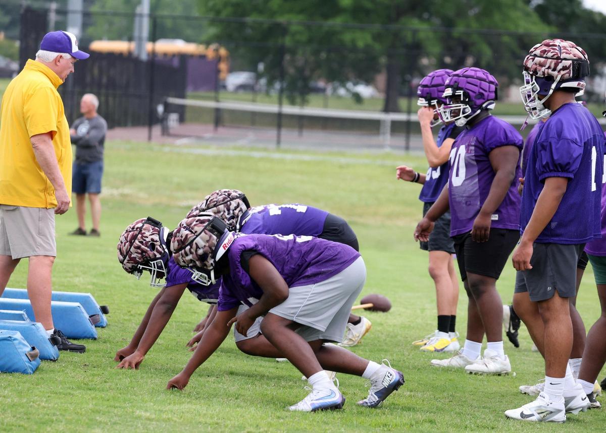 Northwestern High School varsity football players practice after school on Thursday.