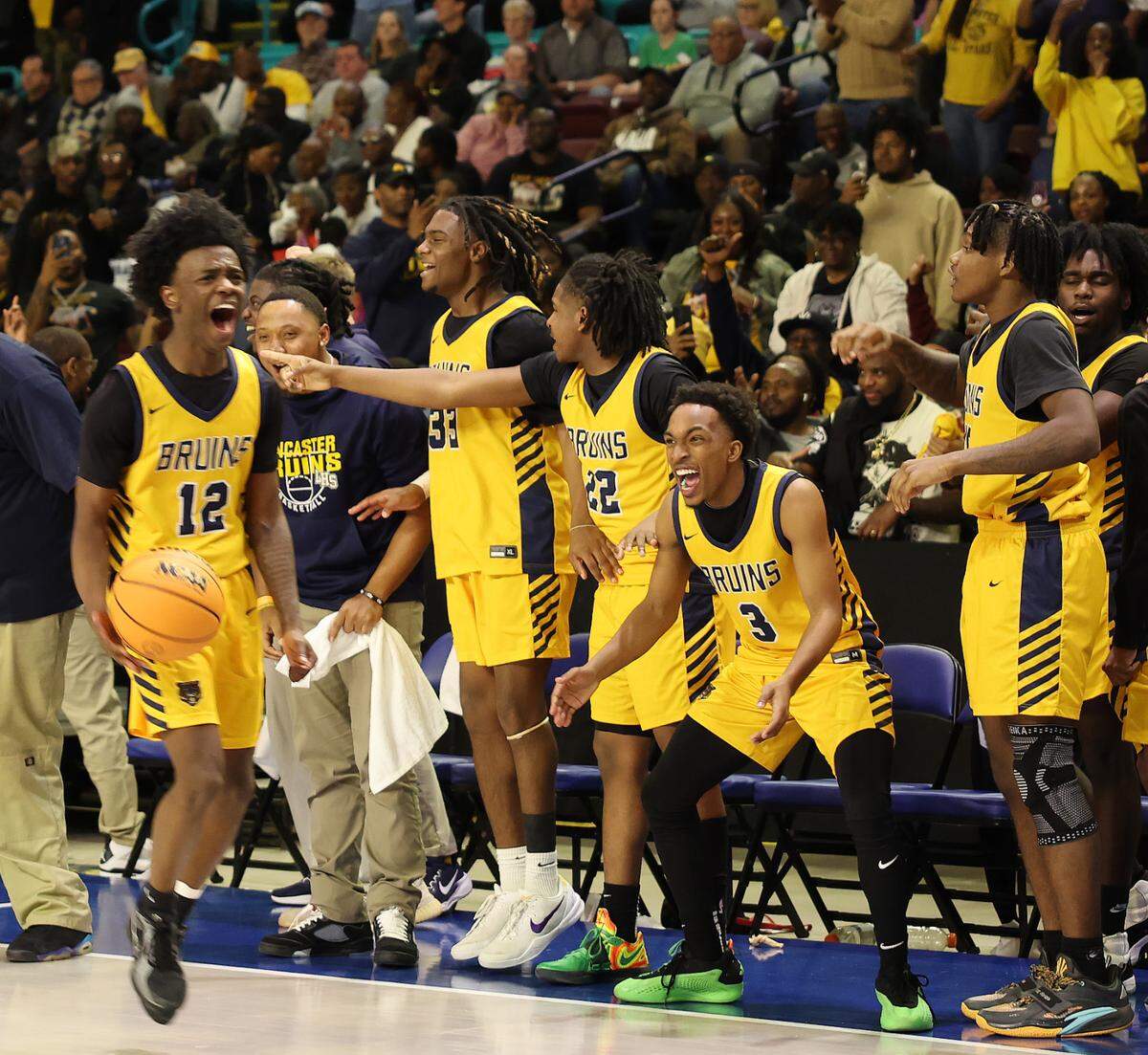 The Lancaster High School boys varsity basketball team celebrates Friday after winning the state championships in Florence.