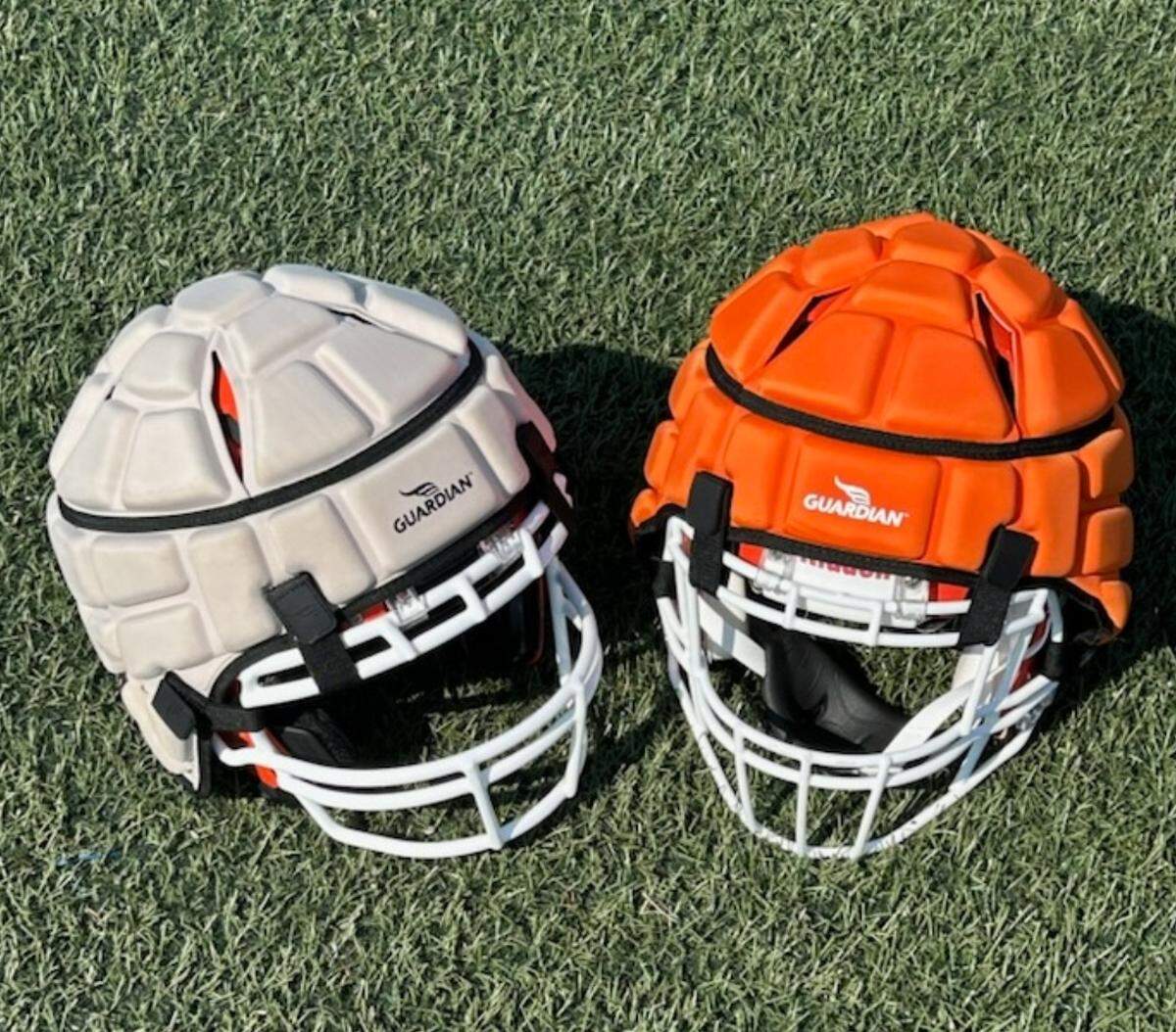 The white Guardian Cap (left) is what Andrew Jackson’s booster club bought in 2022. The orange Guardian Cap (right) is what Lancaster County bought for the school this summer.