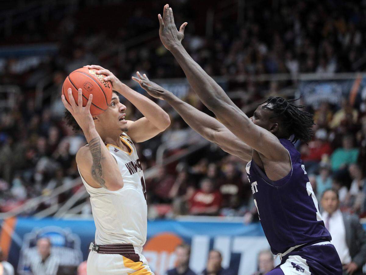 High Point’s Emmanuel Izumabor tries to block Winthrop’s Kelton Talford.