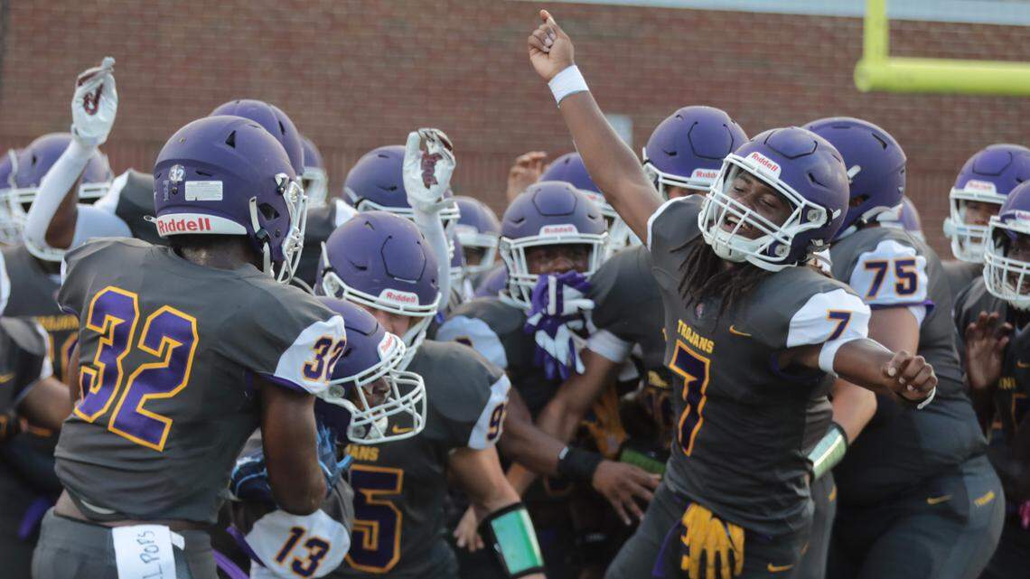 The Northwestern High School varsity football team runs onto the field Friday at the WRHI Kickoff in Rock Hill.