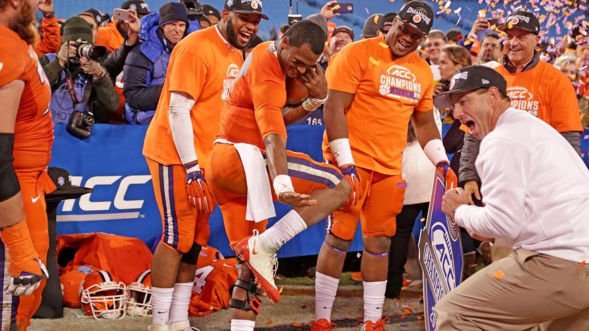 No Tigers had a better season Clemson quarterback Deshaun Watson, doing the Heisman pose, and coach Dabo Swinney, who celebrated their win over North Carolina to claim the ACC Championship.