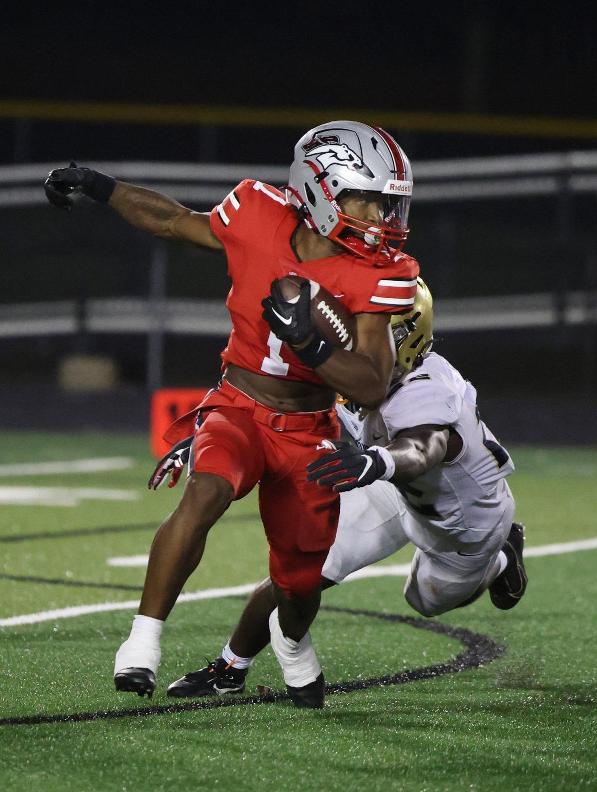 South Pointe’s Mason Hicks carries the ball against Spartanburg’s Cam’Rich Smith Friday in Rock Hill.