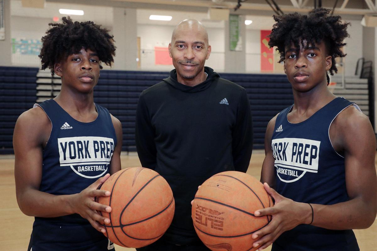 This Herald file photo from 2019 shows Kory Davis, left, and Kendall Davis, right, both basketball players at York Preparatory Academy, are sons of coach Larry Davis, center.