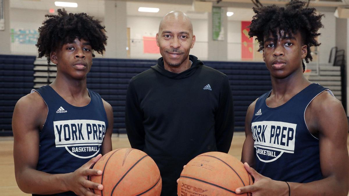 This Herald file photo from 2019 shows Kory Davis, left, and Kendall Davis, right, both basketball players at York Preparatory Academy, are sons of coach Larry Davis, center.