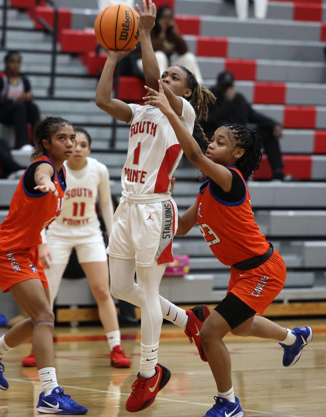 South Pointe’s Kaleigh Lucas takes the shot against Richland Northeast’s Chris Buckley (23) in Rock Hill.