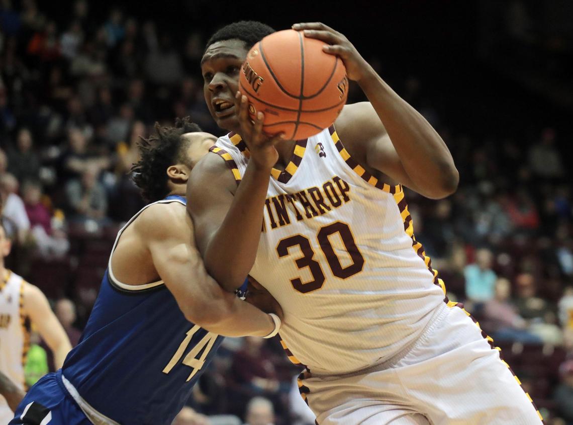D.J. Burns Jr. heads to the basket around Hampton’s Ben Stanley Saturday at the Winthrop Coliseum.