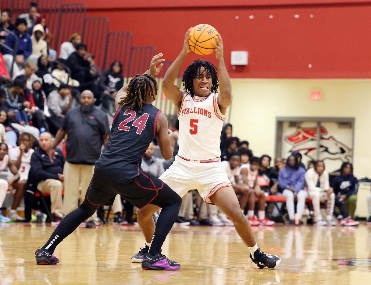 South Pointe’s Caymen Finch looks for an opening around Rock Hill’s Nigel Lightner.
