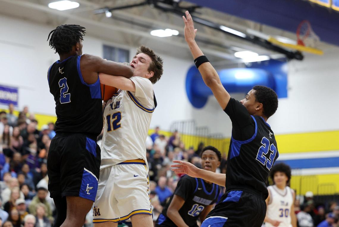 Indian Land’s Sequel Patterson (2) and Fort Mill’s Wallace Campbell fight for control of the ball as Indian Land’s Brent Michael Terrell (23) defends Wednesday in Fort Mill.