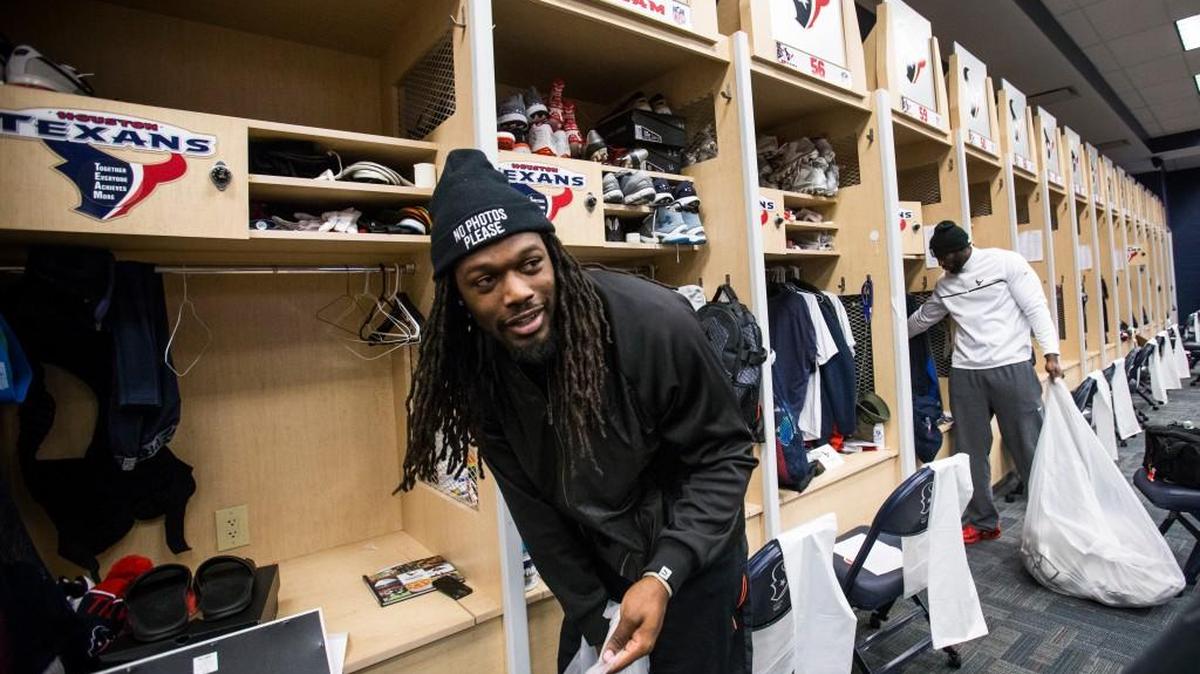 Houston linebackers Jadeveon Clowney, left, and Whitney Mercilus clean out their lockers at NRG Stadium after being eliminated from the playoffs, Sunday in Houston.