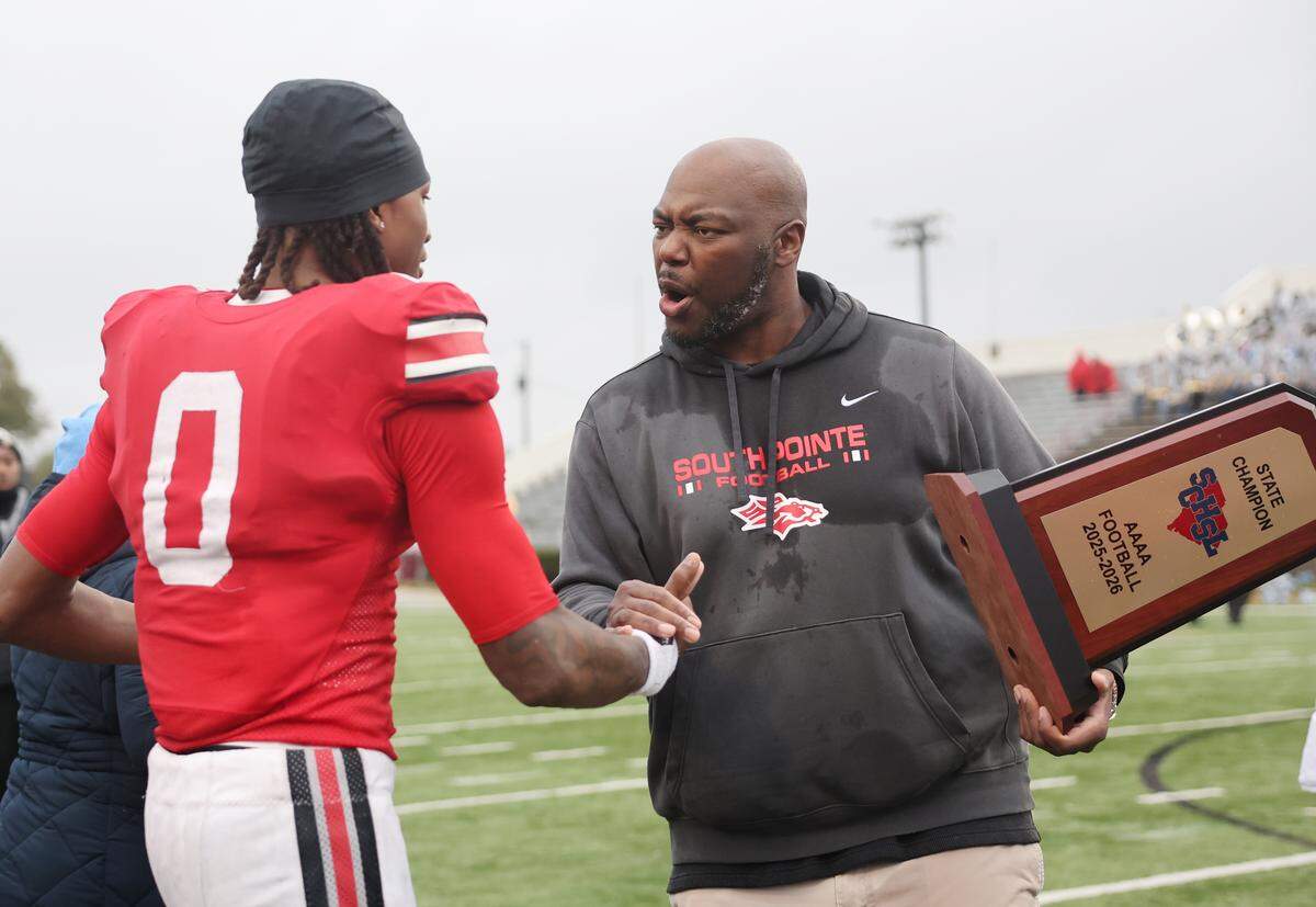 South Pointe High School head football coach Bobby Collins congratulates J'zavien Currence after the team wins the SC High School League Class 4A football championship Saturday, Dec. 6, 2025 in Orangeburg, S.C.