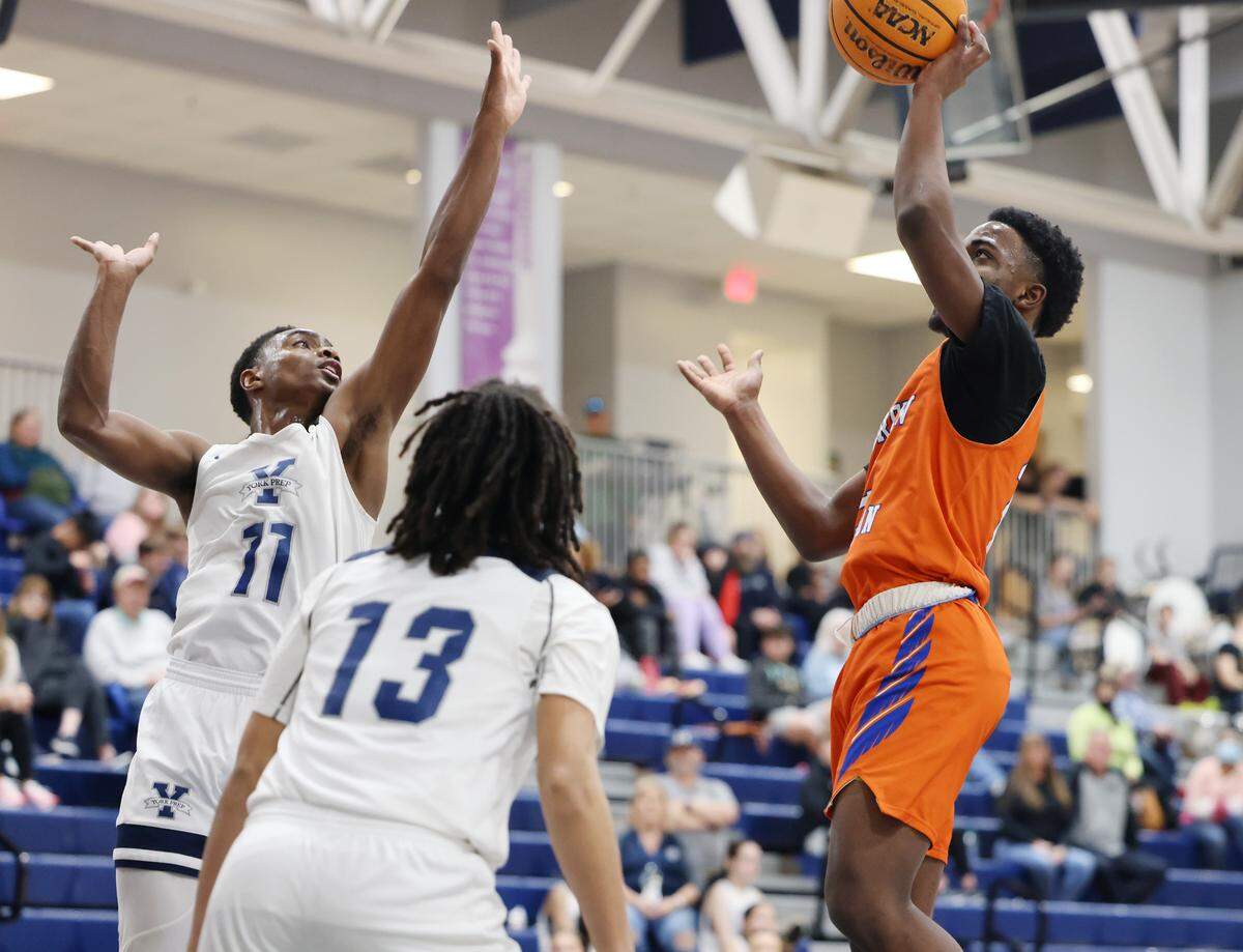 Andrew Jackson’s Damias Seegars shoots the ball against York Prep’s Gianni Wylie (13) and Chance Neal (11).
