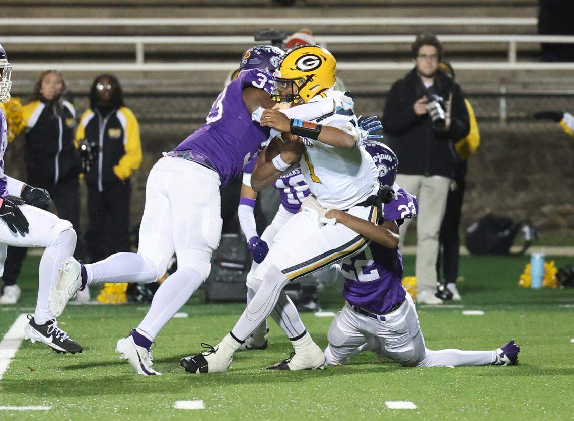 Greenwood’s Triston Lewis is brought down by Northwestern’s Kamerin Mcfadden (33) and Joshua Singleton (22) Friday in Rock Hill, S.C.